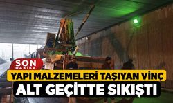 Yapı malzemeleri taşıyan vinç alt geçitte sıkıştı